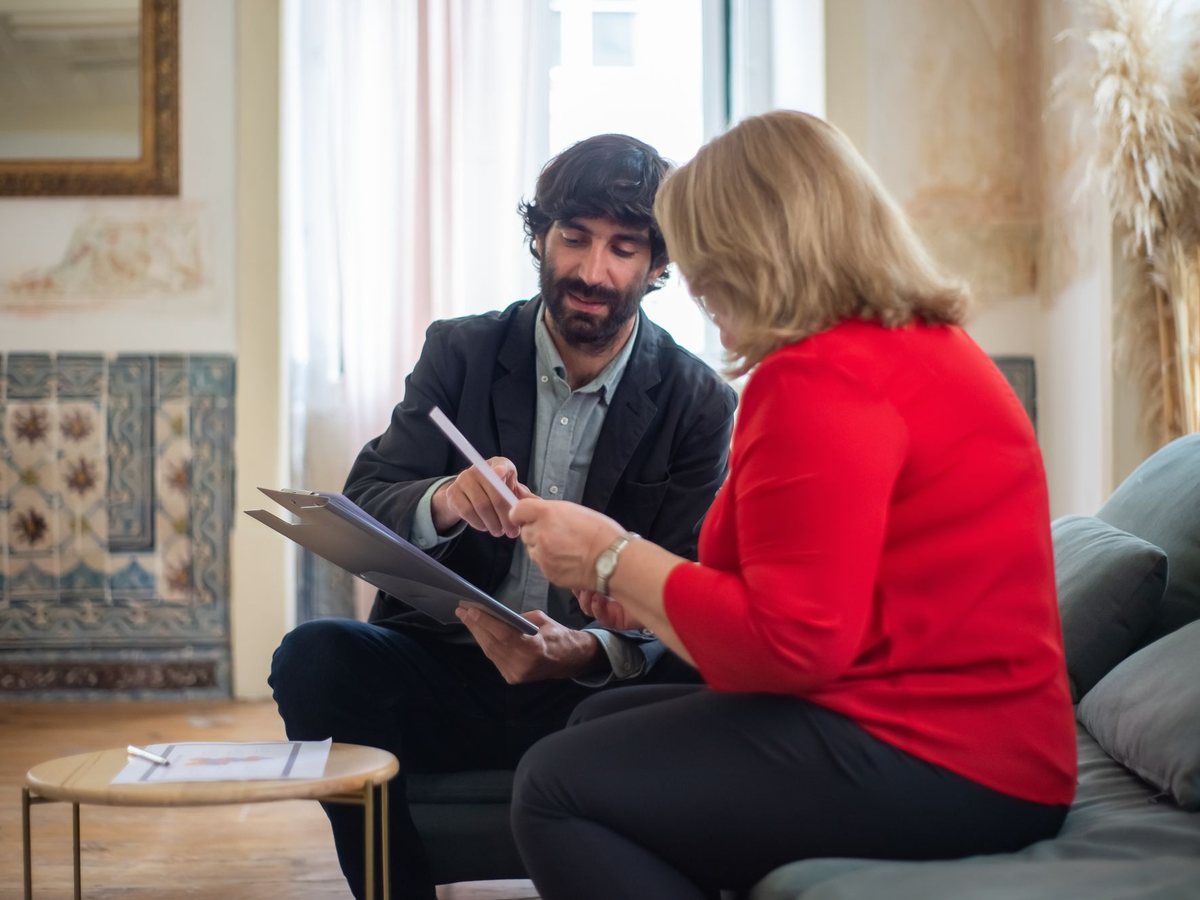 Advisor and client sitting side by side reviewing a plan together